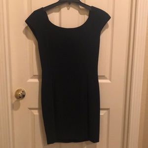 Black cocktail dress with satin swoop in back.